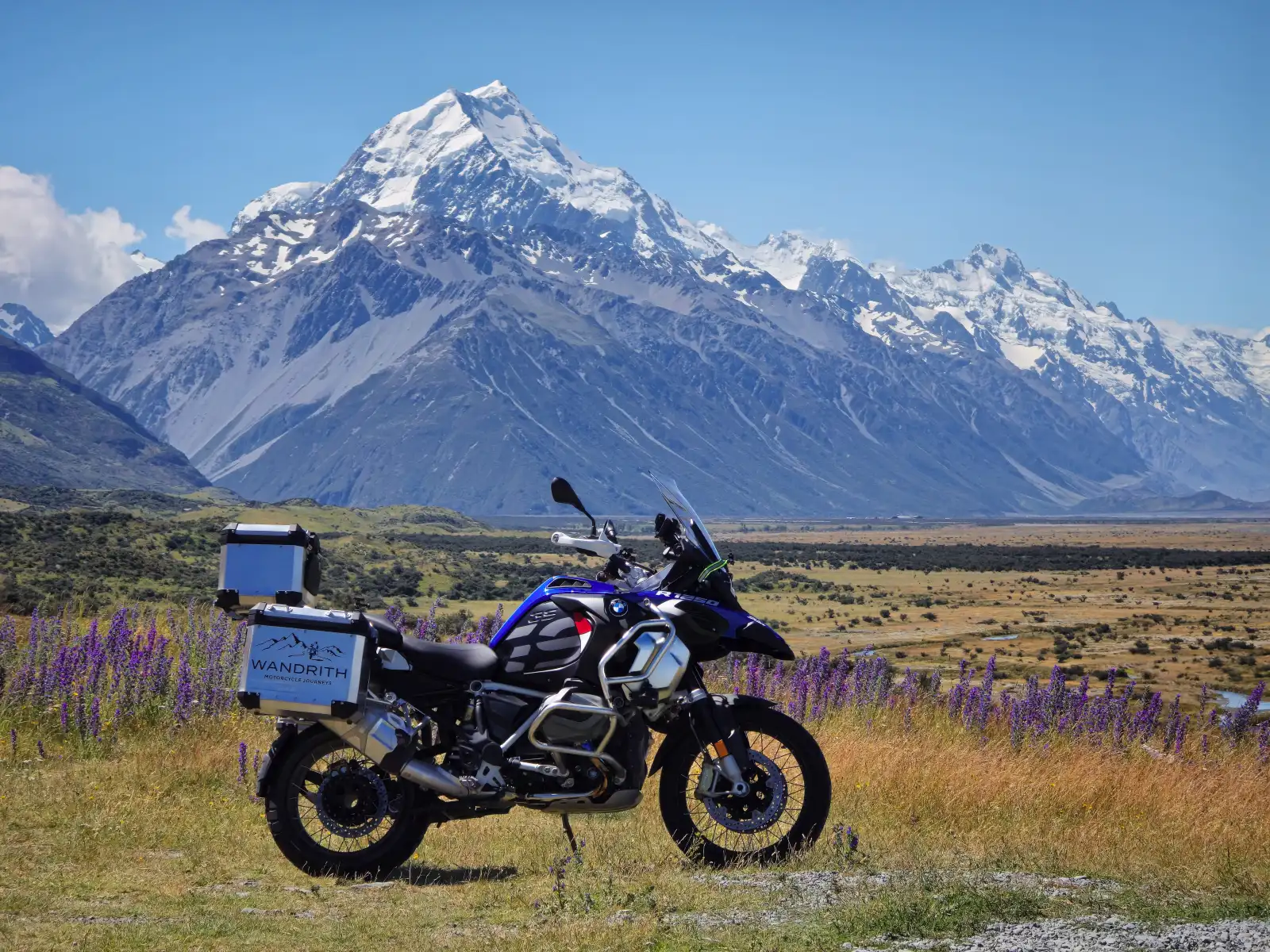 Adventure motorcycle camping under the stars at a remote New Zealand campsite